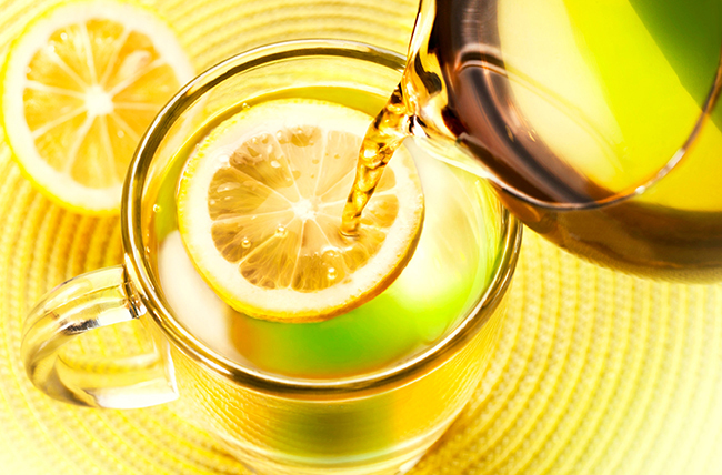 pouring_water_into_pitcher_with_lemon